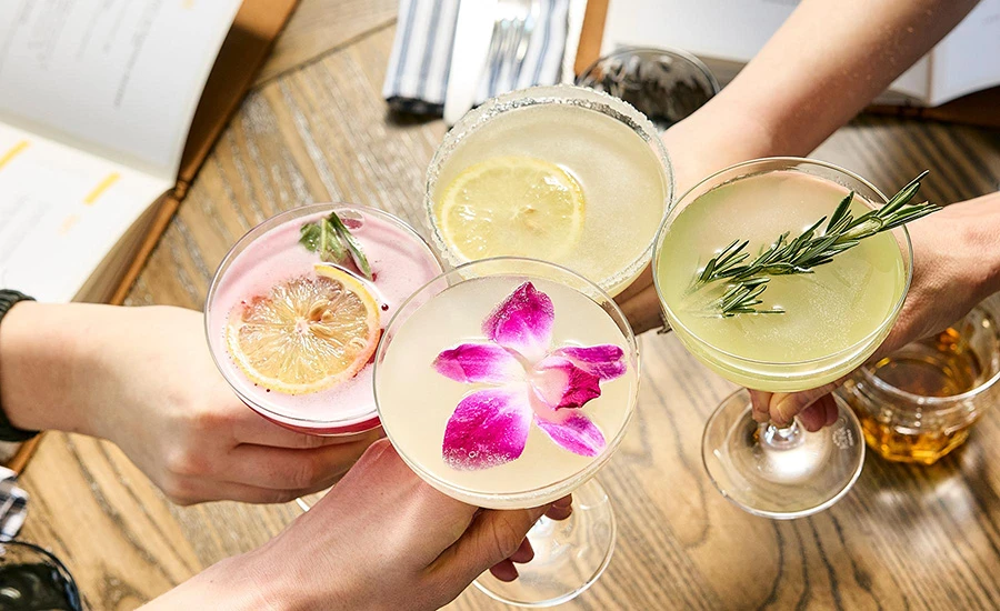 Close up of four coctails on table at HC Tavern + Kitchen